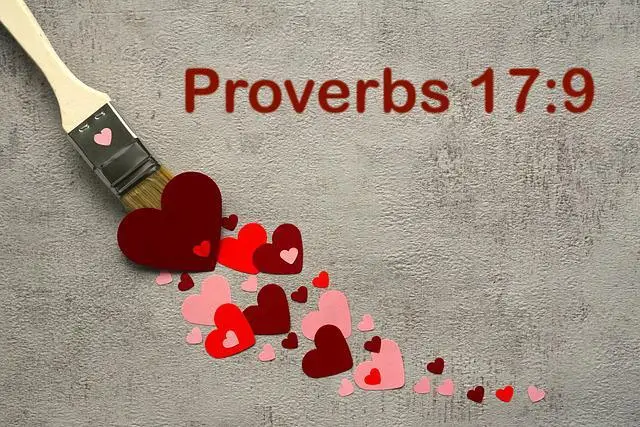 paintbrush painting a pattern of cutout hearts in various shades of red from the bottom right corner to the middle left