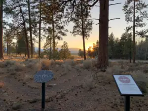 Sisters Community Labyrinth and signs and three sisters mountain range