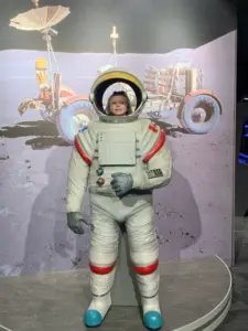 A. contemplates a career as an astronaut